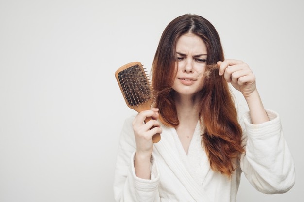 woman-removes-curls-hair-from-comb-loss-health-problems-model_163305-73681
